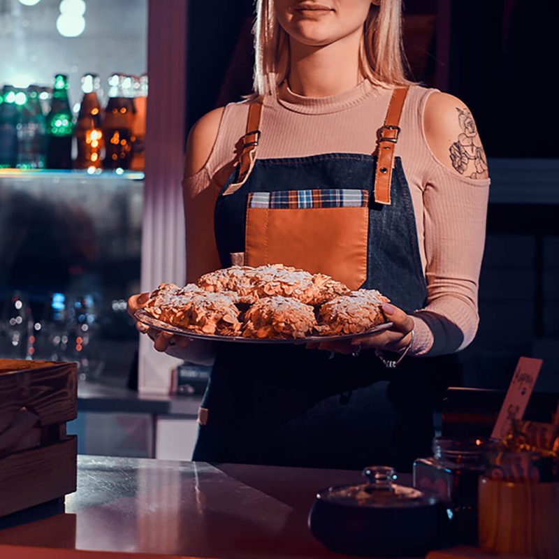 woman-is-working-with-kake-cakes-at-bakery-shop-YQZYRSX